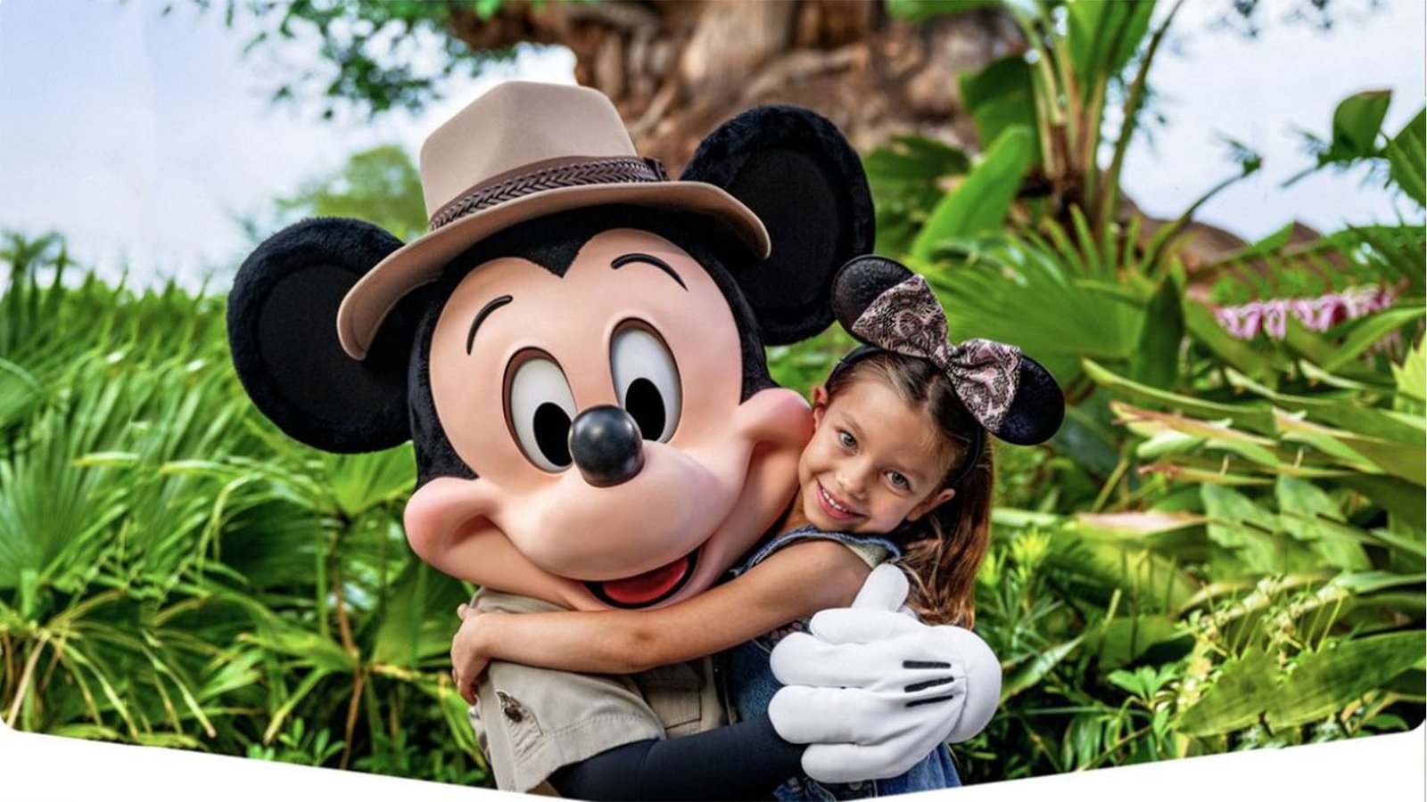 Mickey with hugs young girl at the Tree of Life at Animal Kingdom theme park