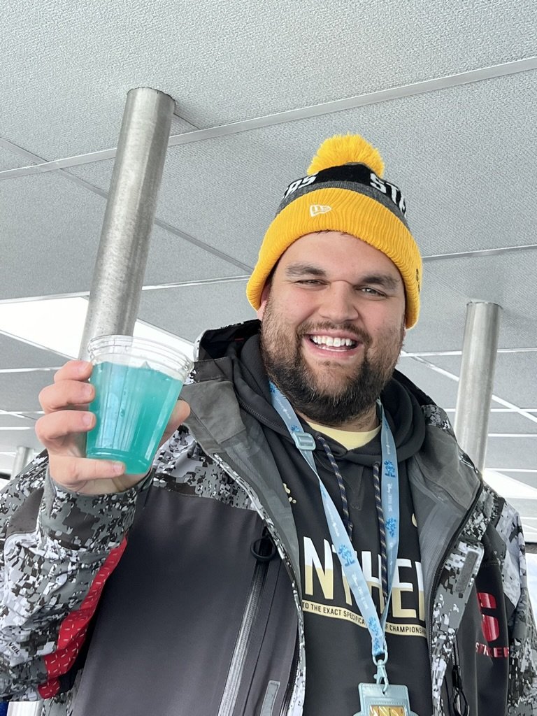 Traveler holding a blue drink aboard the Disney Wonder during an Alaska cruise