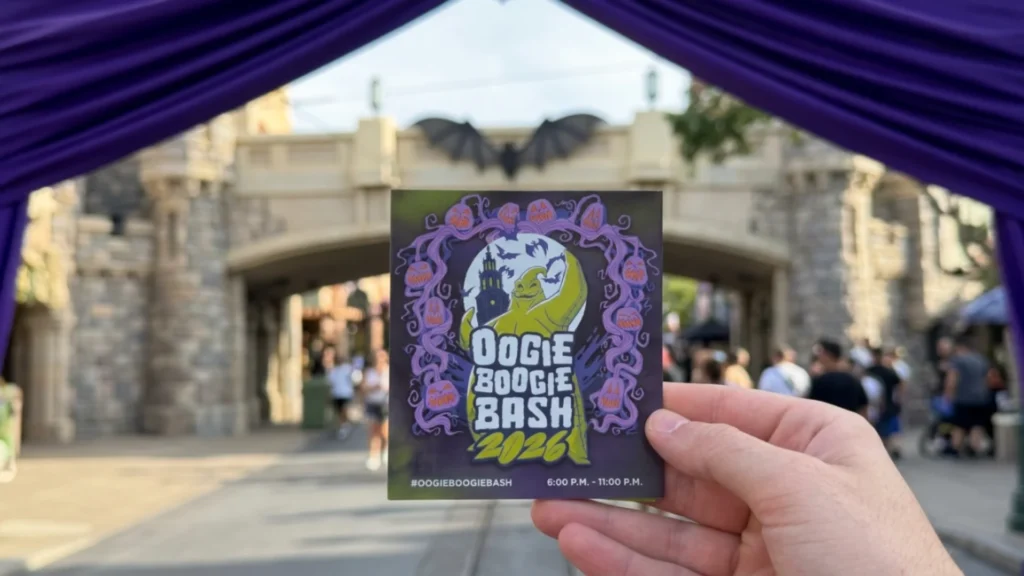 Hand holding an Oogie Boogie Bash 2026 event guide card at Disney California Adventure